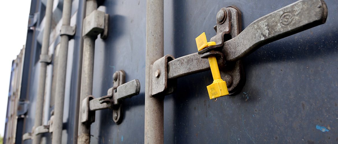 Door latch of an intermodal container with a seal in place